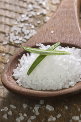 sea salt with herbs in a wooden spoon