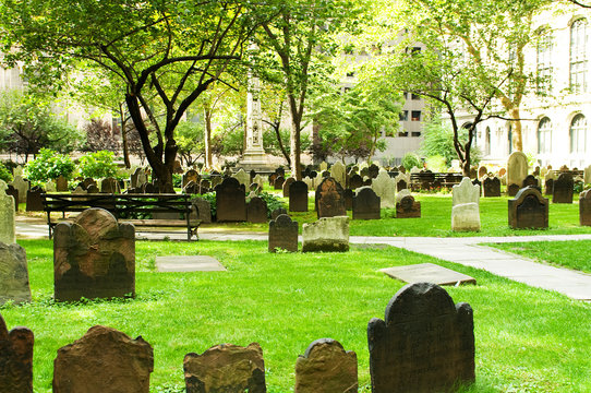 Cemetery with many tombstones on the bright day