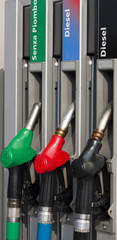 Closeup of Gas Pump Nozzles at Gas Station