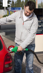 Customer Refilling Car at Gas Station