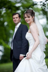 lovely young wedding couple - freshly wed groom and bride posing