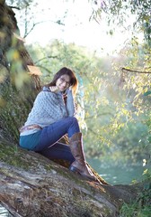 Junge Frau sitzt auf einem Baum