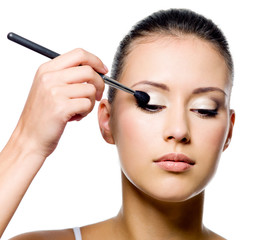 woman applying eyeshadow with brush