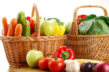 Composition with basket and vegetables on kitchen table