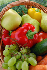 Composition with vegetables and wicker basket on kitchen table