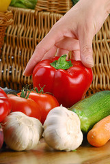 Hand holding red pepper