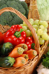 Composition with basket and vegetables on kitchen table