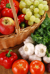 Composition with basket and vegetables on kitchen table