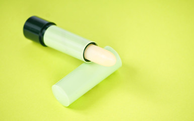 Lipstick isolated on green background
