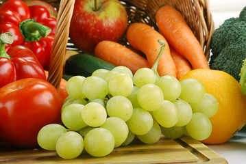 Composition with basket and vegetables on kitchen table