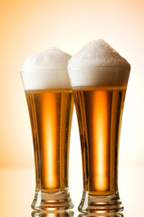 Beer glasses against the colorful gradient background