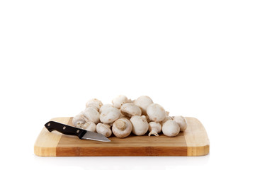 Fresh vegetables mushrooms, wooden chopping board.