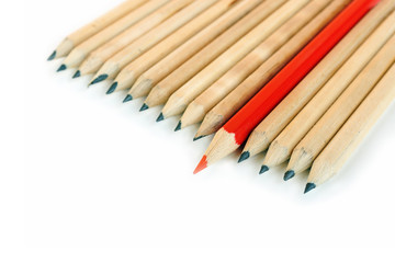 A row of rough graphite pencils with color red one
