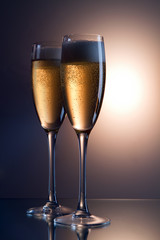 A glass of champagne, isolated on a black background.
