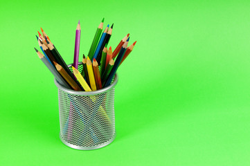 Many colorful pencils on the color background