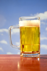 refreshing beer mug on sky background