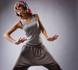 Beautiful dancing girl isolated on grey background