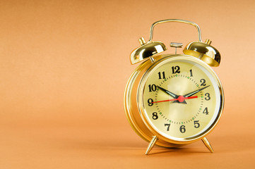 Time concept - alarm clock against colorful background