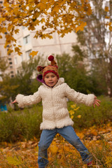 Child jumping in autumn