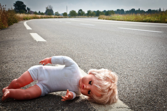 doll leave on a highway lane