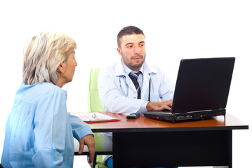 Doctor using laptop and having patient visit