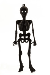 black plastic skeleton over white