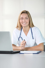 Beautiful smilng nurse working in the office