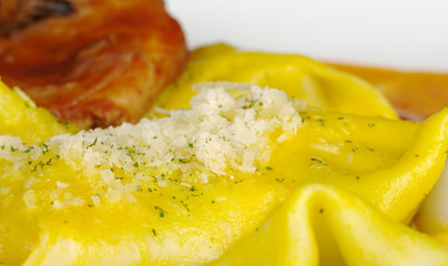 Grated Parmesan on ravioli with meat