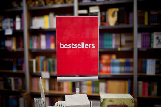 Bestsellers area in bookstore - many books in the background.