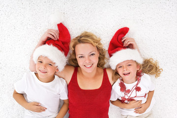 Woman and kids laying on the floor at christmas time