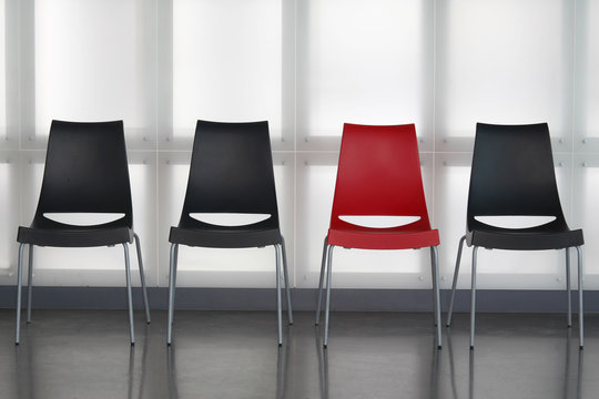 Fours chairs in line againt wall