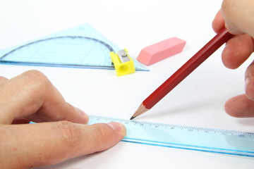 Pencil in male hand and ruler