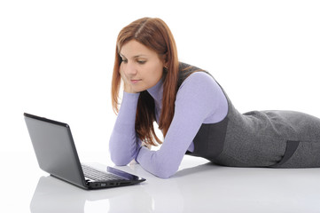 woman with laptop lying on the floor