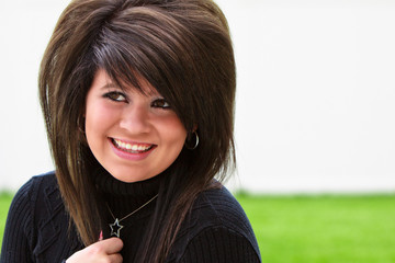 Beautiful teen smiling in a black sweater