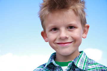 Cute young boy smiling at the viewer