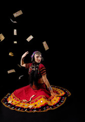 woman in traditional indian costume againist falling money
