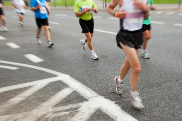 People running in marathon in intentional motion blur