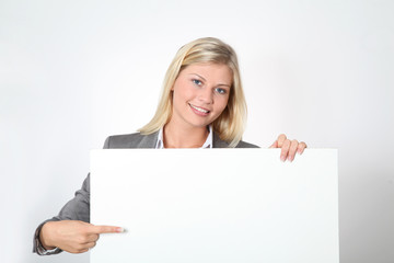 Fototapeta premium Businesswoman holding white panel