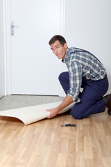 Closeup of artisan installing ground floor in room