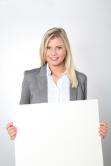 Businesswoman holding white panel