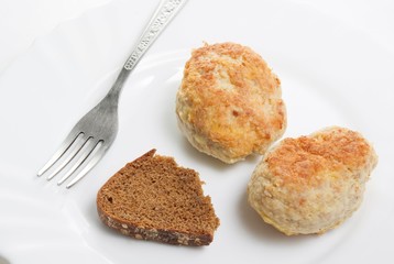 Fresh meatloaf (chop) in plate with bread and fork.