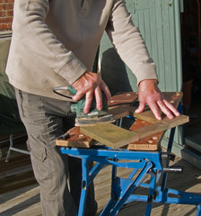 Sanding wood with an electric sander