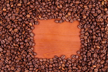 Coffee beans on wooden background with space for text