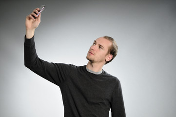 young man creating photos with mobile