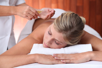 Fototapeta na wymiar Closeup of beautiful woman laying on a massage bed