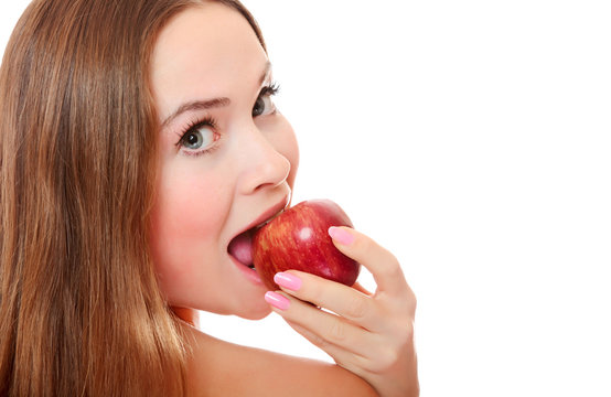 Pretty girl with open mouth eating red apple
