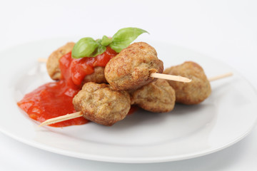 Roast meatballs with tomato sauce. Shallow DOF