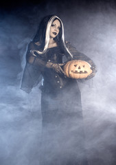 Halloween witch with a pumpkin.