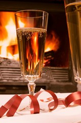 glasses of champagne in front of fireplace