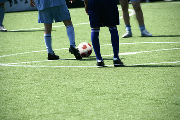 men playing soccer game on green field